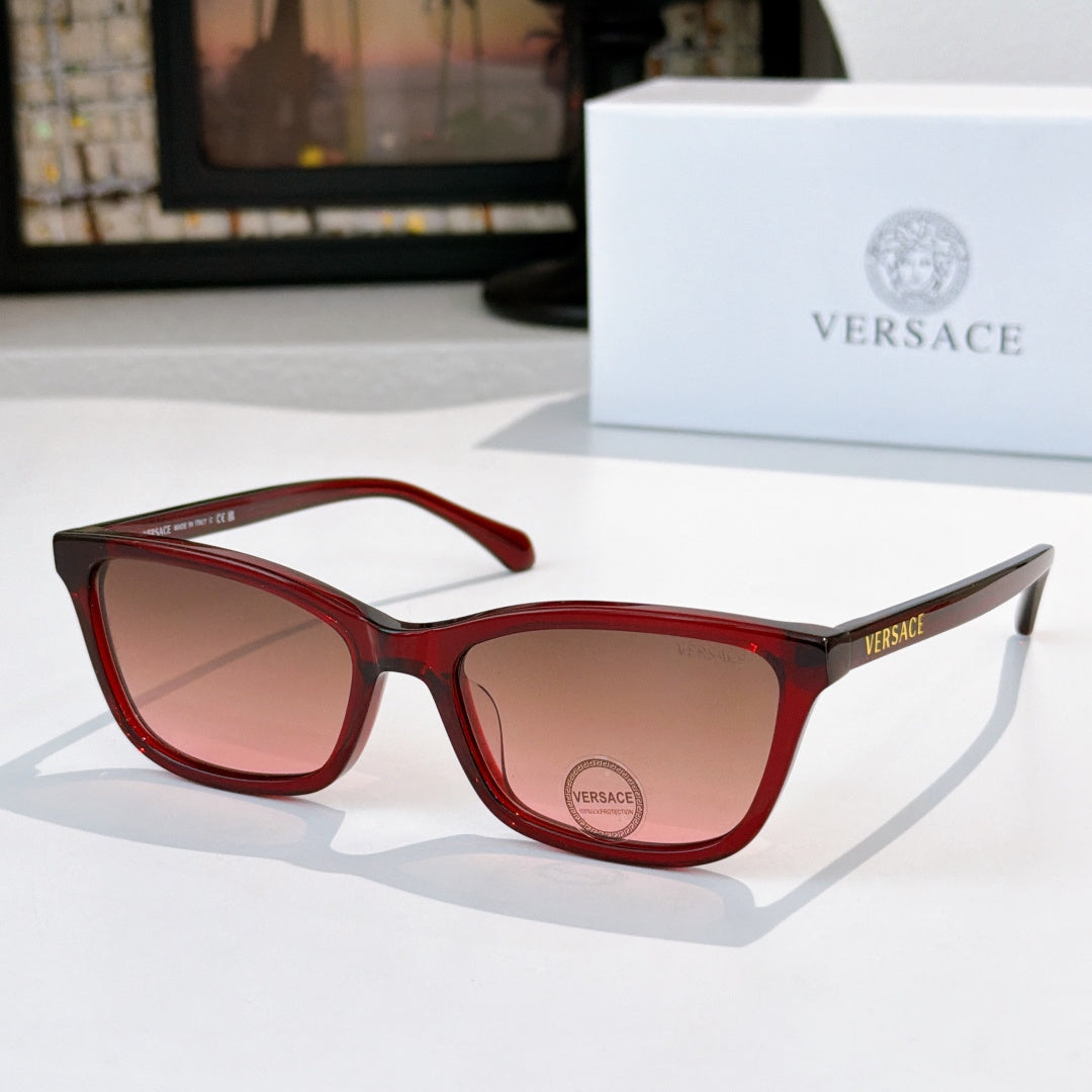 Versace sunglasses with red acetate frames and pink-tinted lenses, Versace logo.
