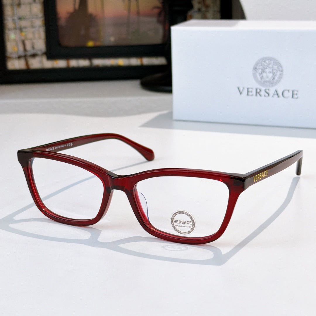 Versace eyeglasses with red acetate frames and clear lenses, logo on lens.