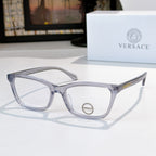 Versace eyeglasses with light blue-gray acetate frames and clear lenses, logo on temple.