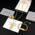 Gold-tone Dior charm necklace, bracelet, and hoop earrings in gift box