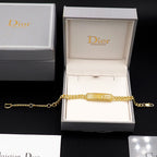 Gold-tone bracelet with chain and clasp, displayed in Dior gift box
