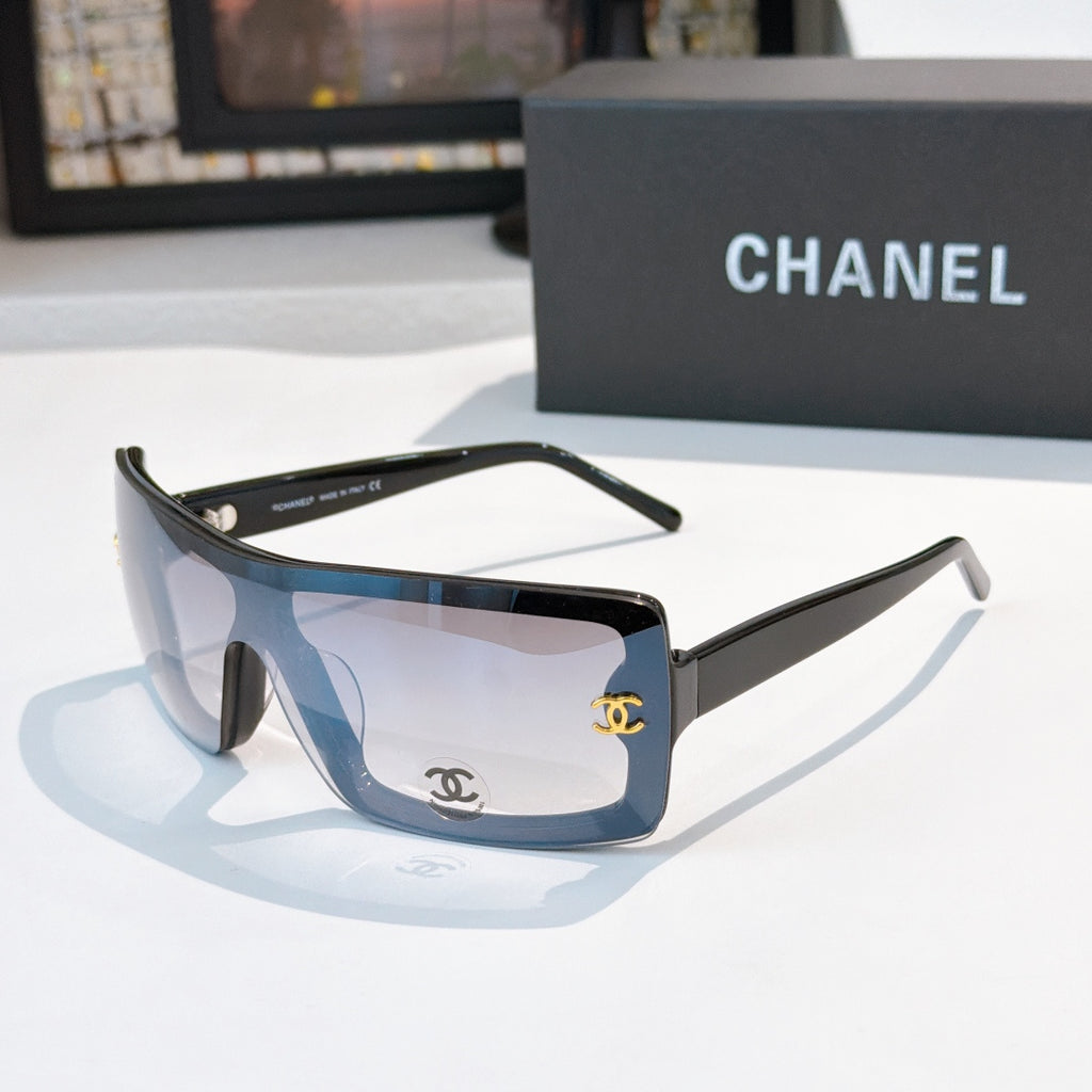 Chanel sunglasses, dark frame with light blue lens tint and gold CC logo on temple