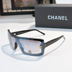 Chanel sunglasses, dark frame with light blue lens tint and gold CC logo on temple
