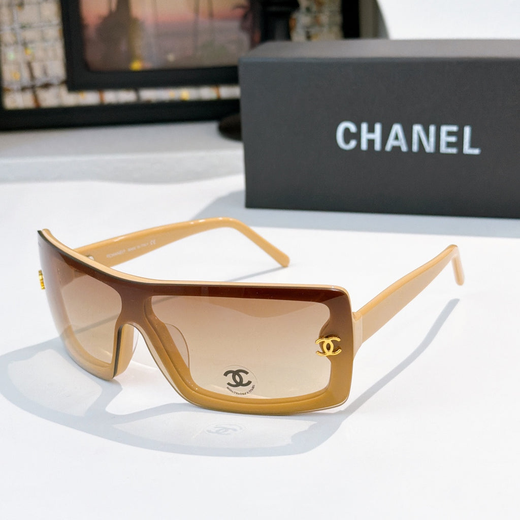 Chanel sunglasses, tan frame with warm brown lens tint and gold CC logo