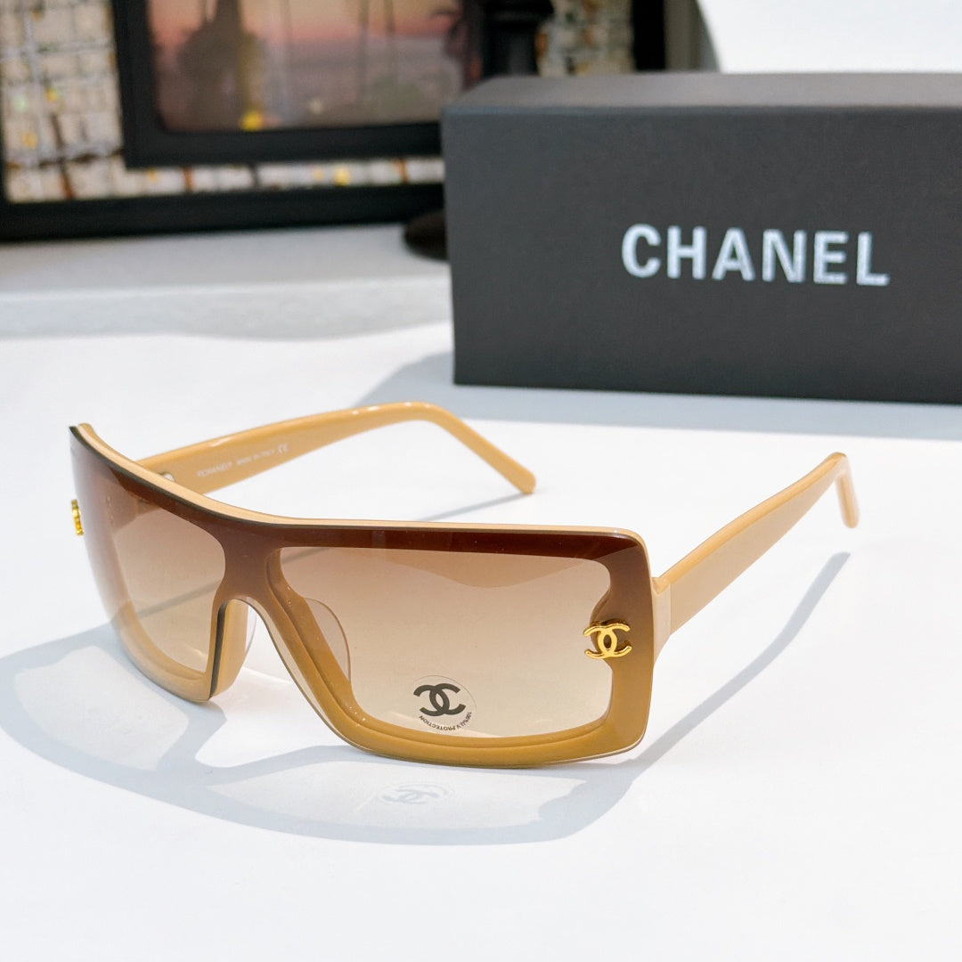 Chanel sunglasses, tan frame with warm brown lens tint and gold CC logo