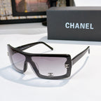 Chanel sunglasses, dark frame with pale purple lens tint and gold CC logo on temple