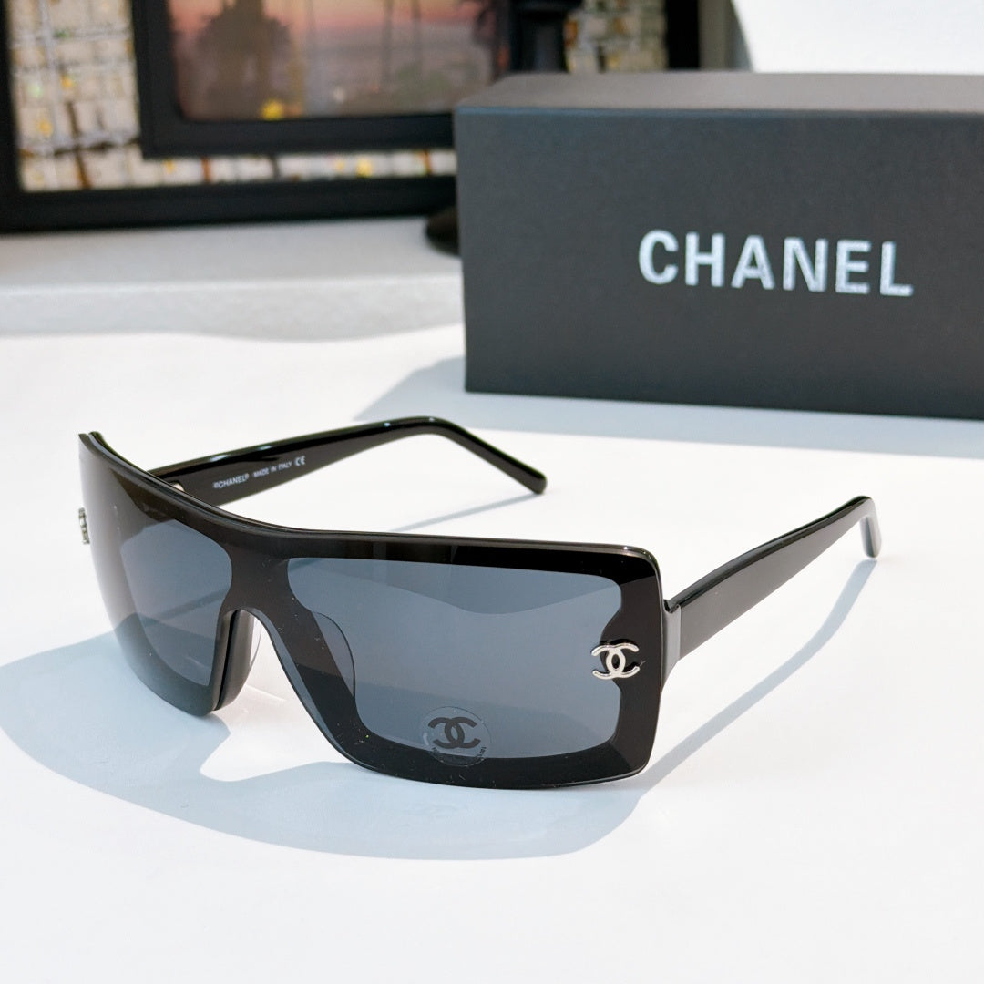 Chanel sunglasses, dark frame with blue lens tint and gold CC logo on temple