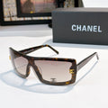 Chanel sunglasses, tortoiseshell frame with gray tint and gold CC logo on temple