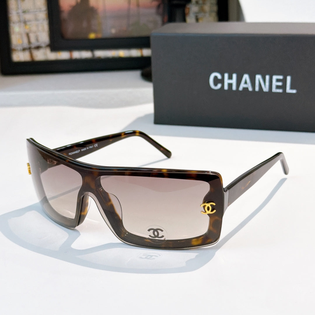Chanel sunglasses, tortoiseshell frame with gray tint and gold CC logo on temple