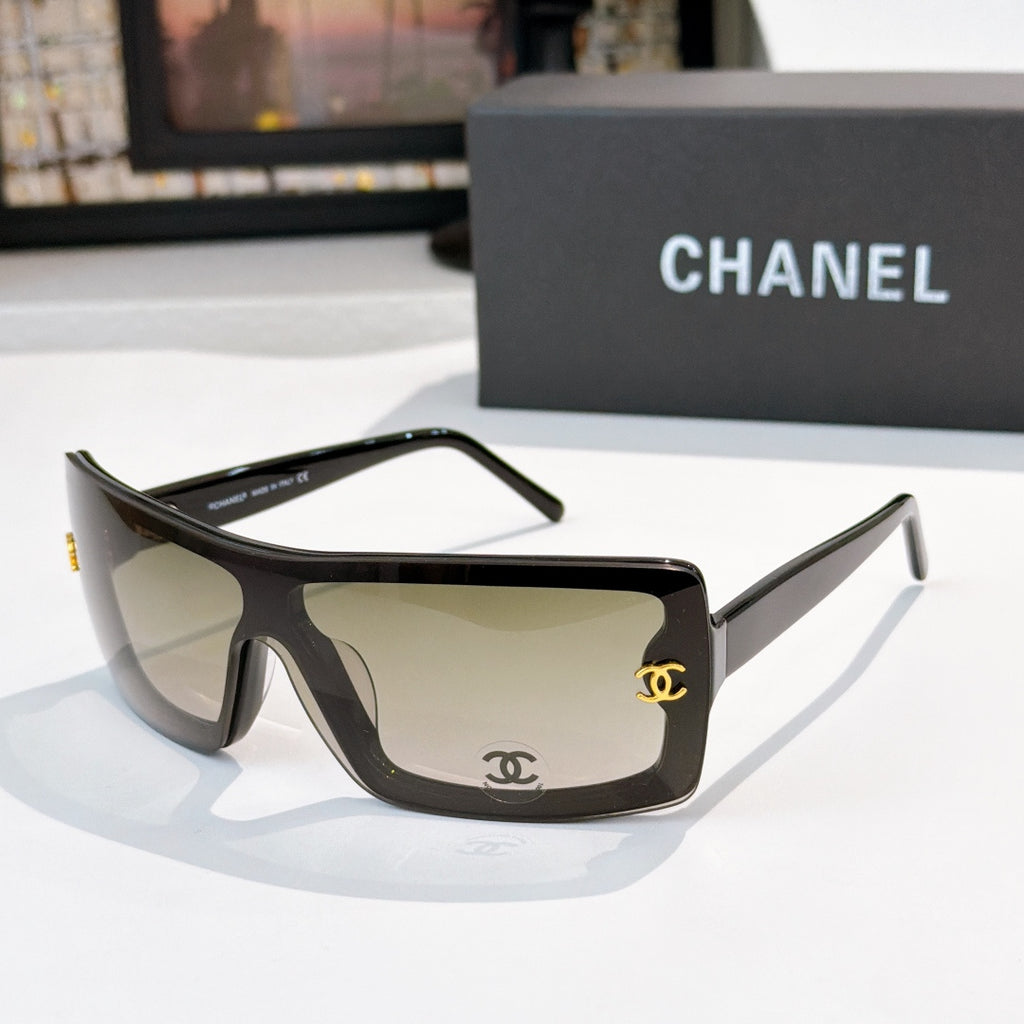 Chanel sunglasses, dark frame with beige lens tint and gold CC logo on temple
