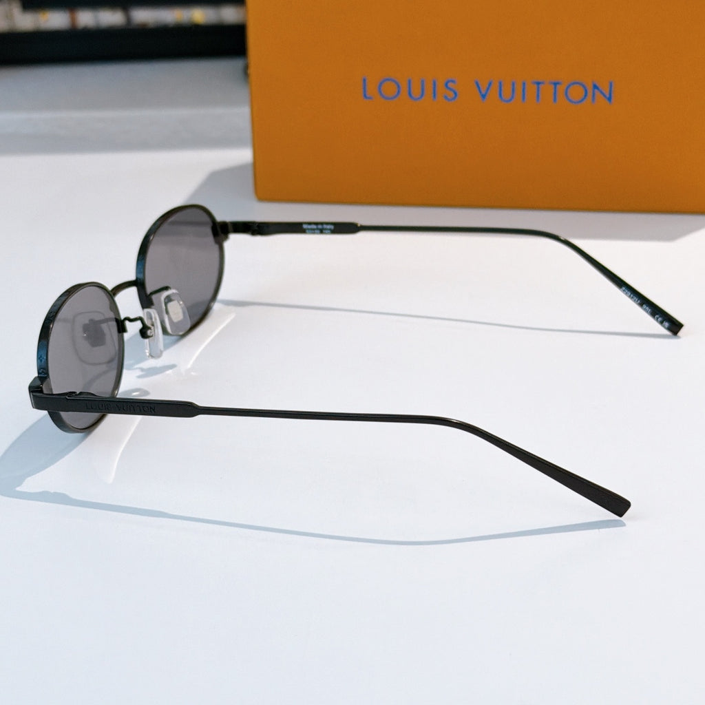 Louis Vuitton sunglasses, side profile with dark frames and clear temple tips.
