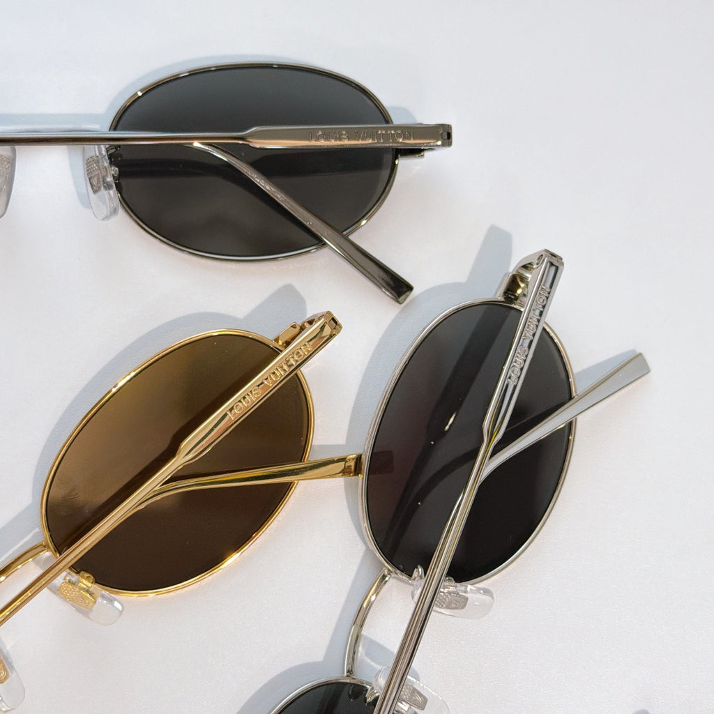 Louis Vuitton sunglasses, close-up of overlapping frames with tinted lenses and gold details.