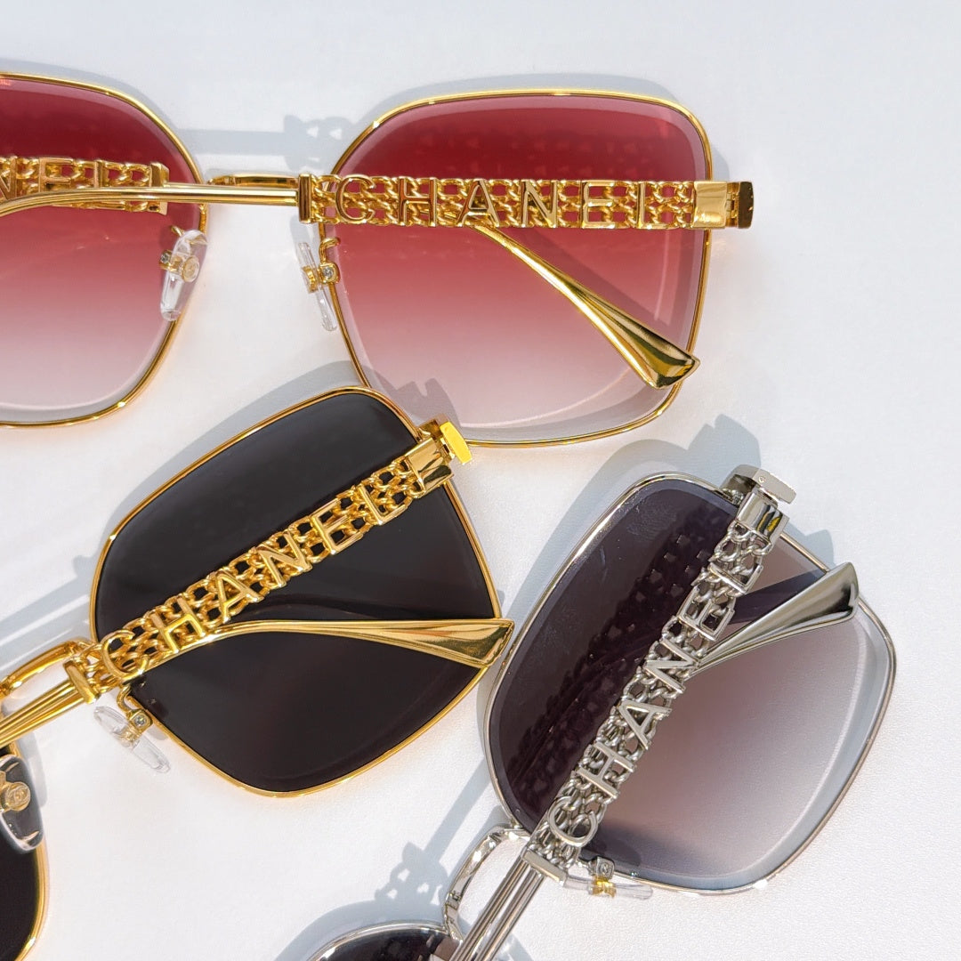 Chanel sunglasses close-up: red, black, and gray lenses with gold and silver logo temples
