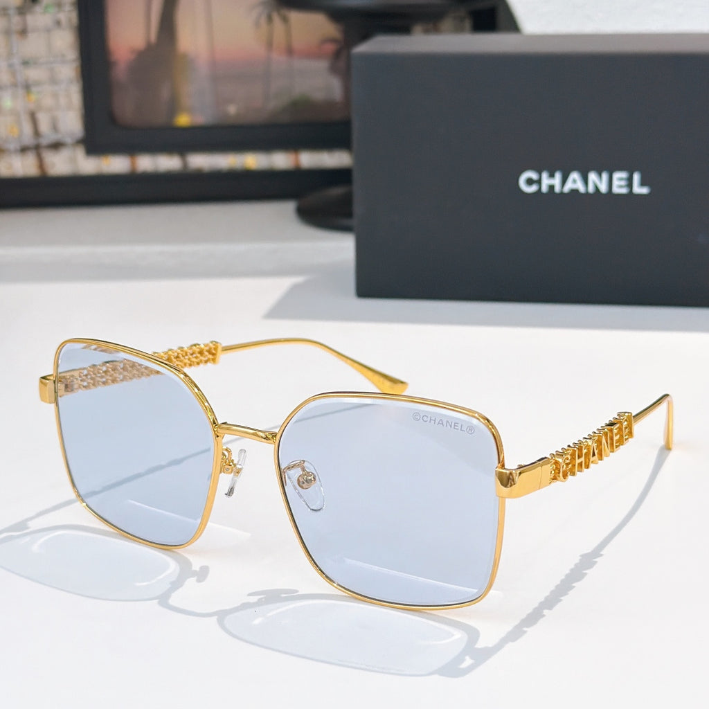 Chanel gold-tone square sunglasses with clear lenses and logo detail on temples