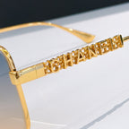 Chanel gold-tone temple arm with engraved CHANEL lettering and lens edge