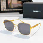 Chanel gold-tone square sunglasses with dark gray lenses and textured logo temples