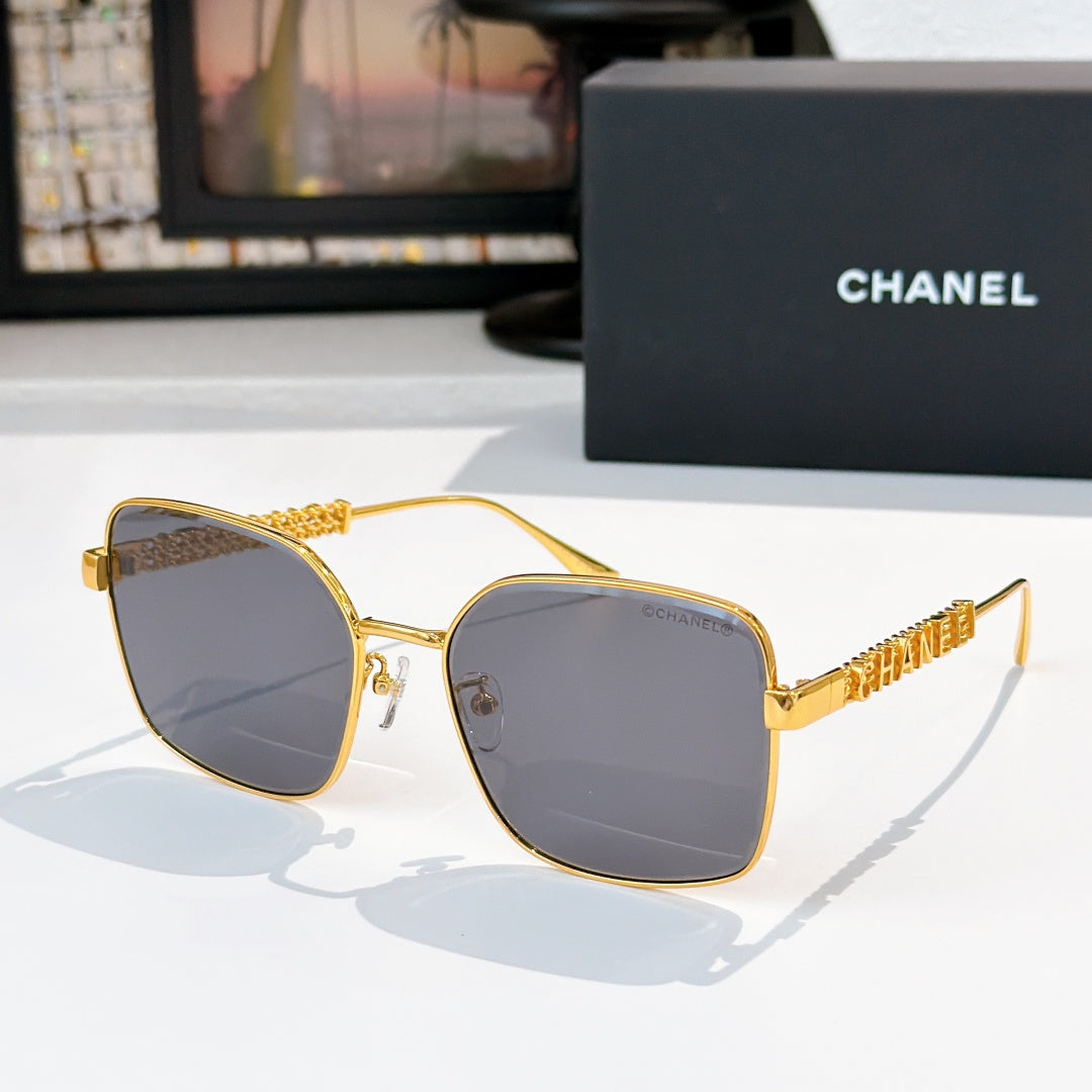 Chanel gold-tone square sunglasses with dark gray lenses and textured logo temples