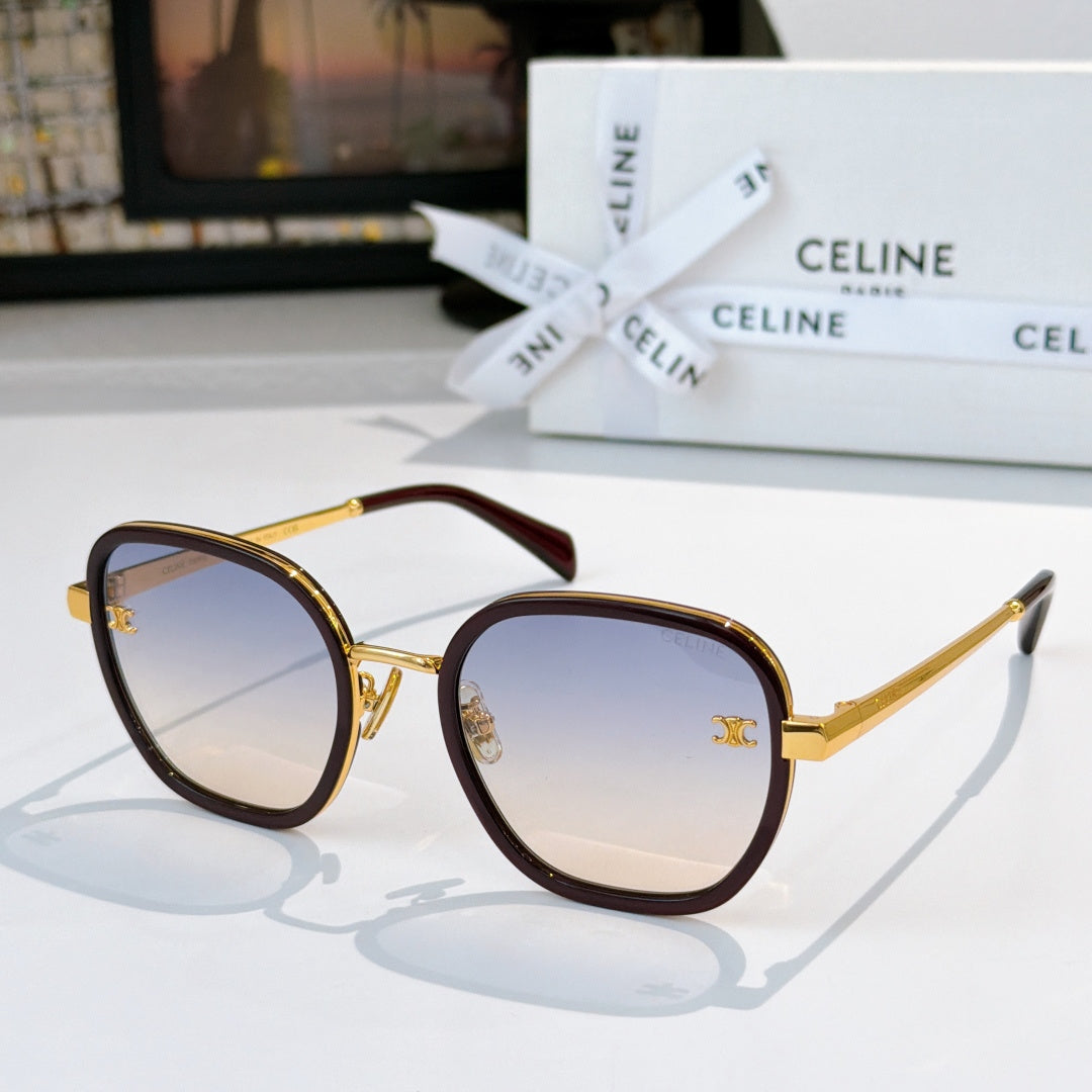 Round sunglasses with gold frame and dark brown temples, light blue gradient lenses