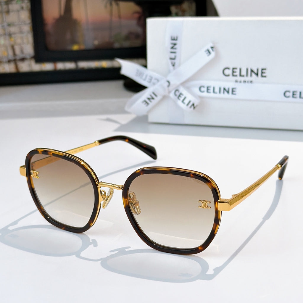 Round sunglasses with dark tortoise frame and gold accents, amber-tinted gradient lenses
