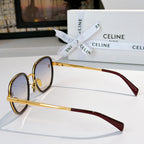 Round sunglasses, side view with gold frame and red/burgundy temples, dark lenses