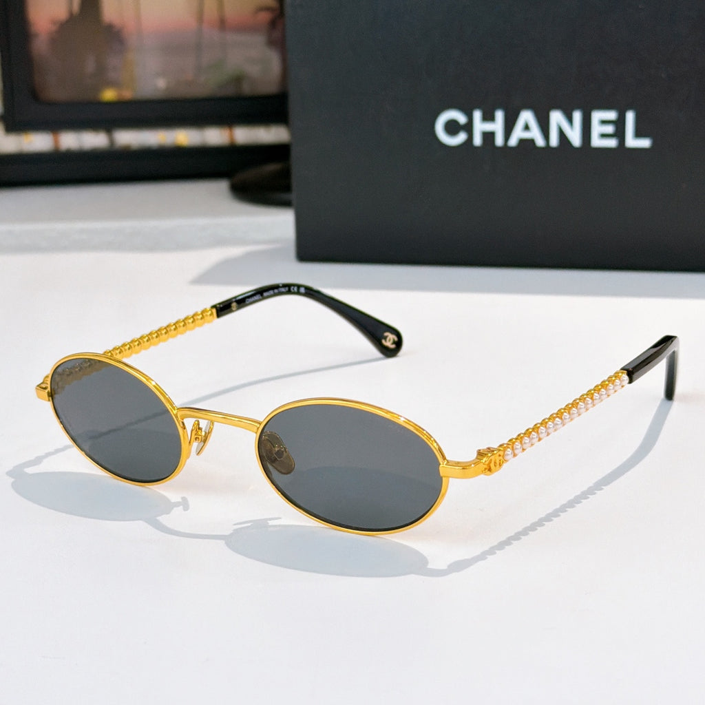 Gold round sunglasses with dark gray lenses and beaded chain temples