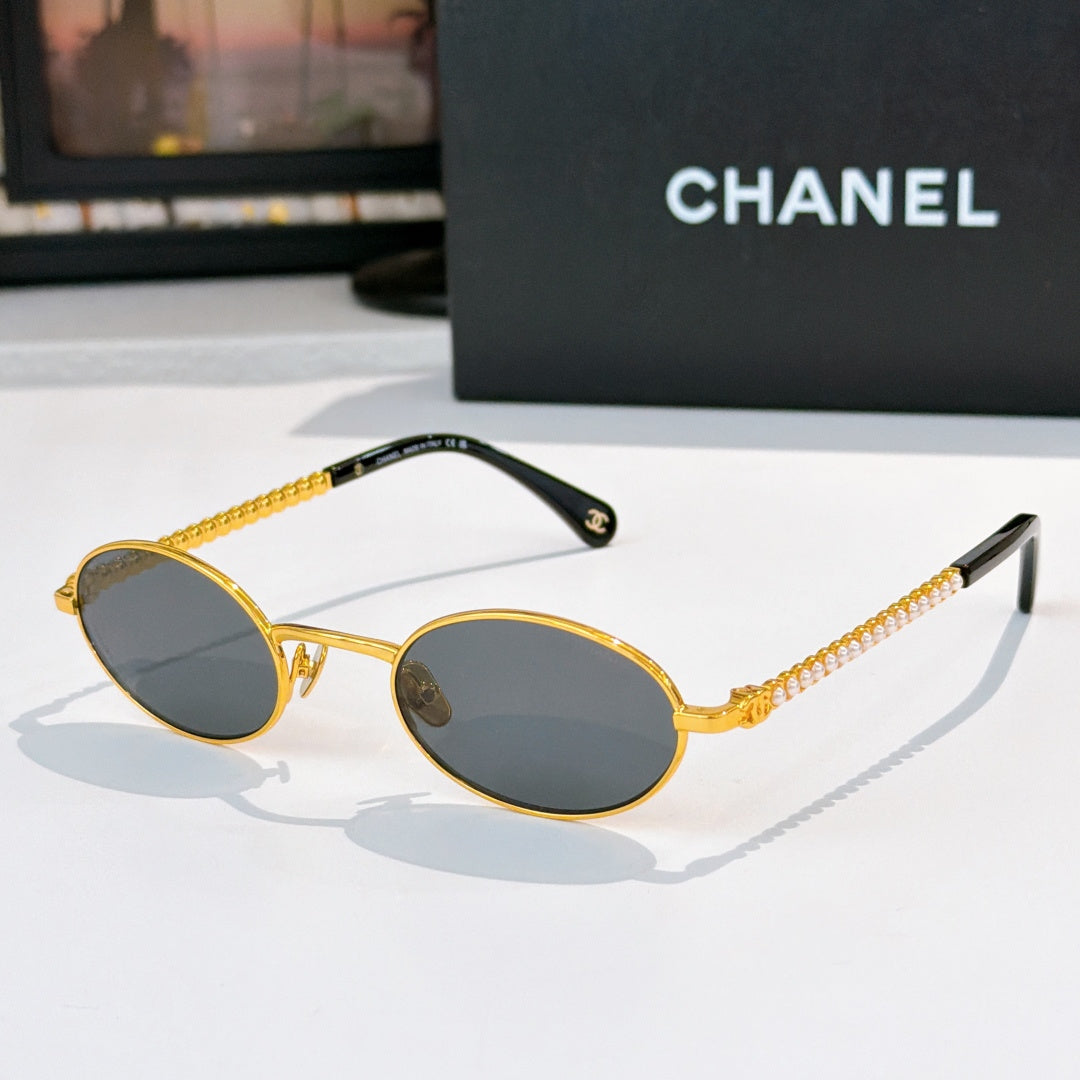Gold round sunglasses with dark gray lenses and beaded chain temples