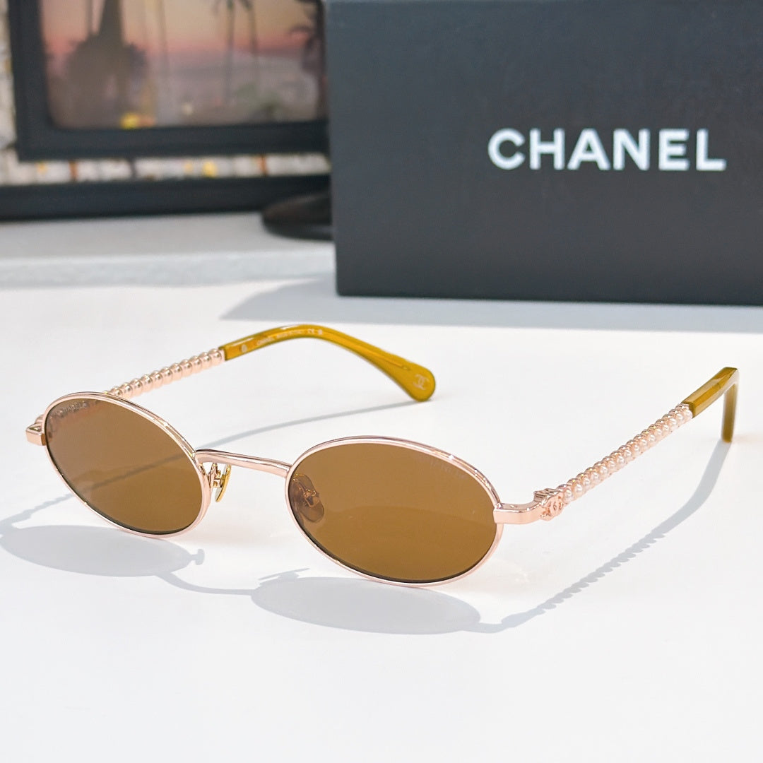 Rose-gold round sunglasses with brown lenses and beaded chain temples