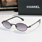 Black round sunglasses with purple lenses and beaded chain temples