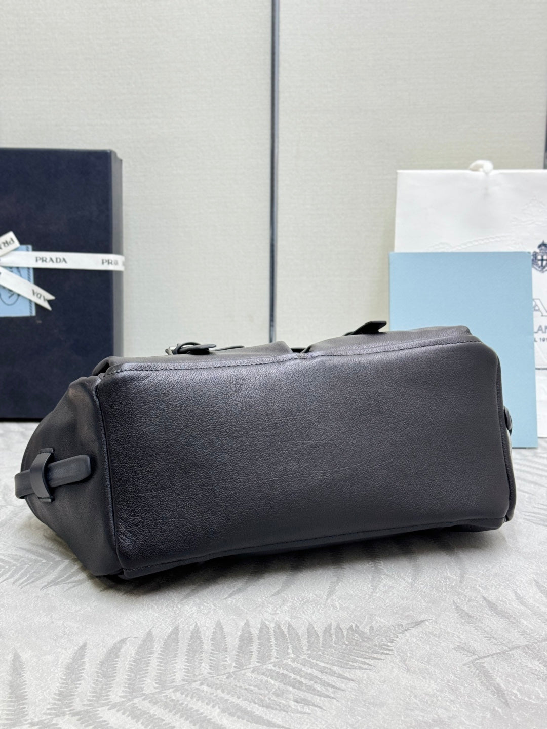 Prada black leather shoulder bag with adjustable strap and zip-top opening