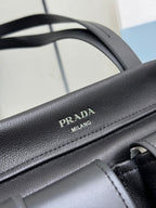 Prada Milano embossed logo on black leather handle strap