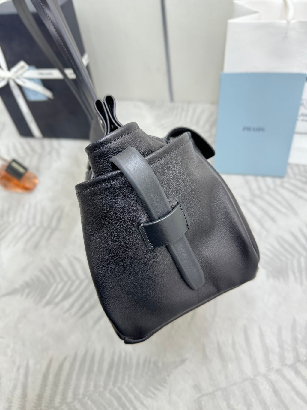Prada black leather mini bag with short handles and front buckle closure