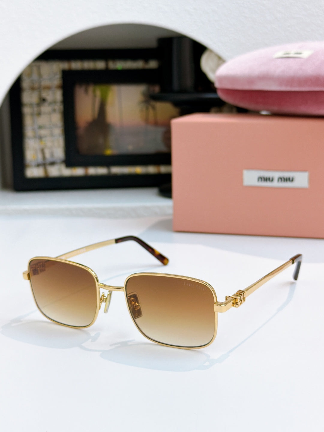 MiuMiu glasses with amber lenses and gold square frame