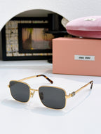 MiuMiu glasses with dark gray lenses and gold square frame