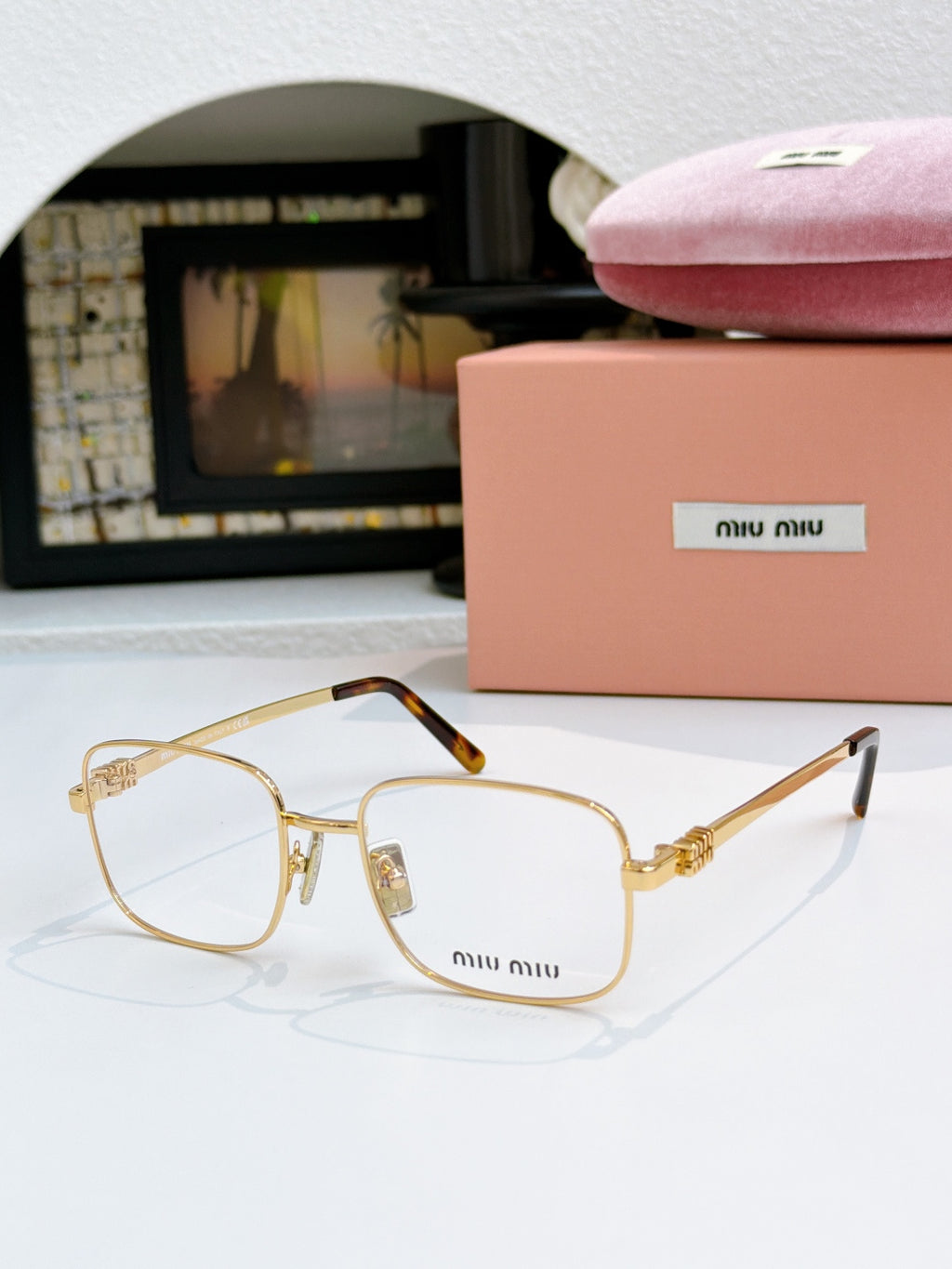MiuMiu glasses with clear lenses and gold frame with gold hinges