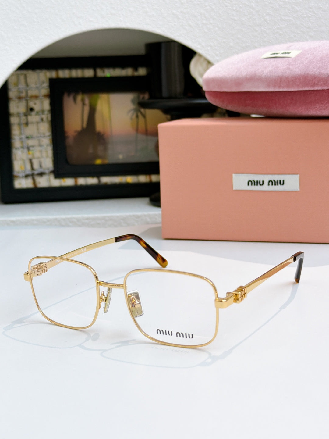 MiuMiu glasses with clear lenses and gold frame with gold hinges