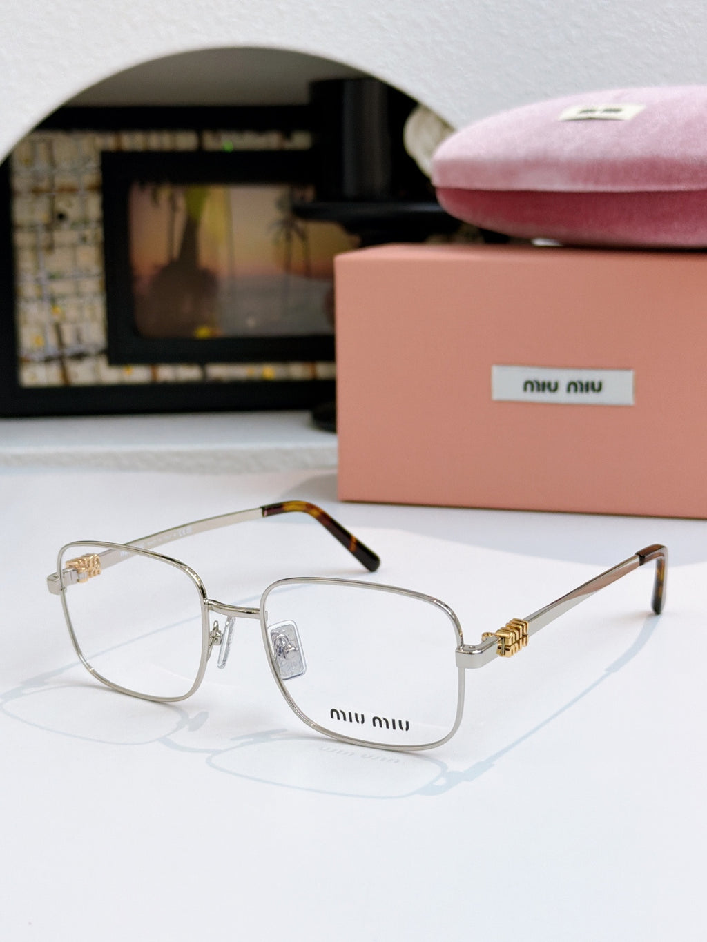 MiuMiu glasses with clear lenses and thin gold metal frame
