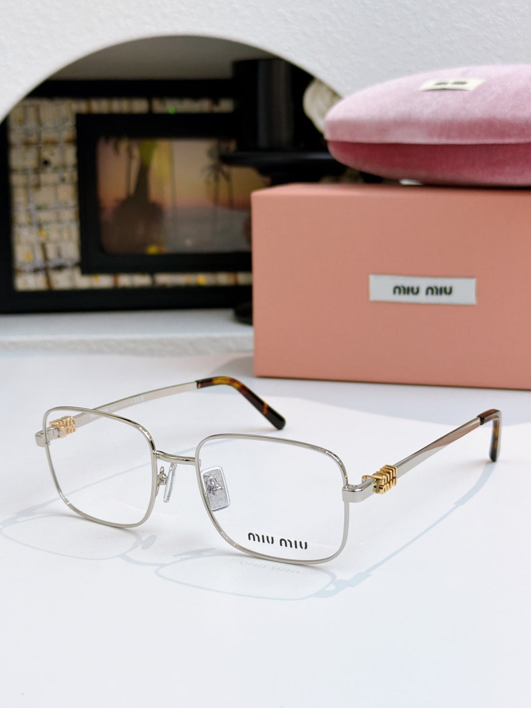 MiuMiu glasses with clear lenses and thin gold metal frame