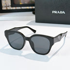 Prada black cat-eye sunglasses with dark tinted lenses