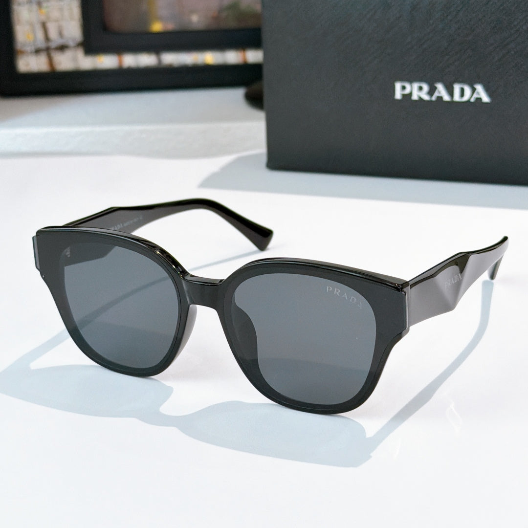 Prada black cat-eye sunglasses with dark tinted lenses