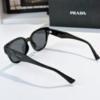Prada black oval sunglasses with dark tinted lenses