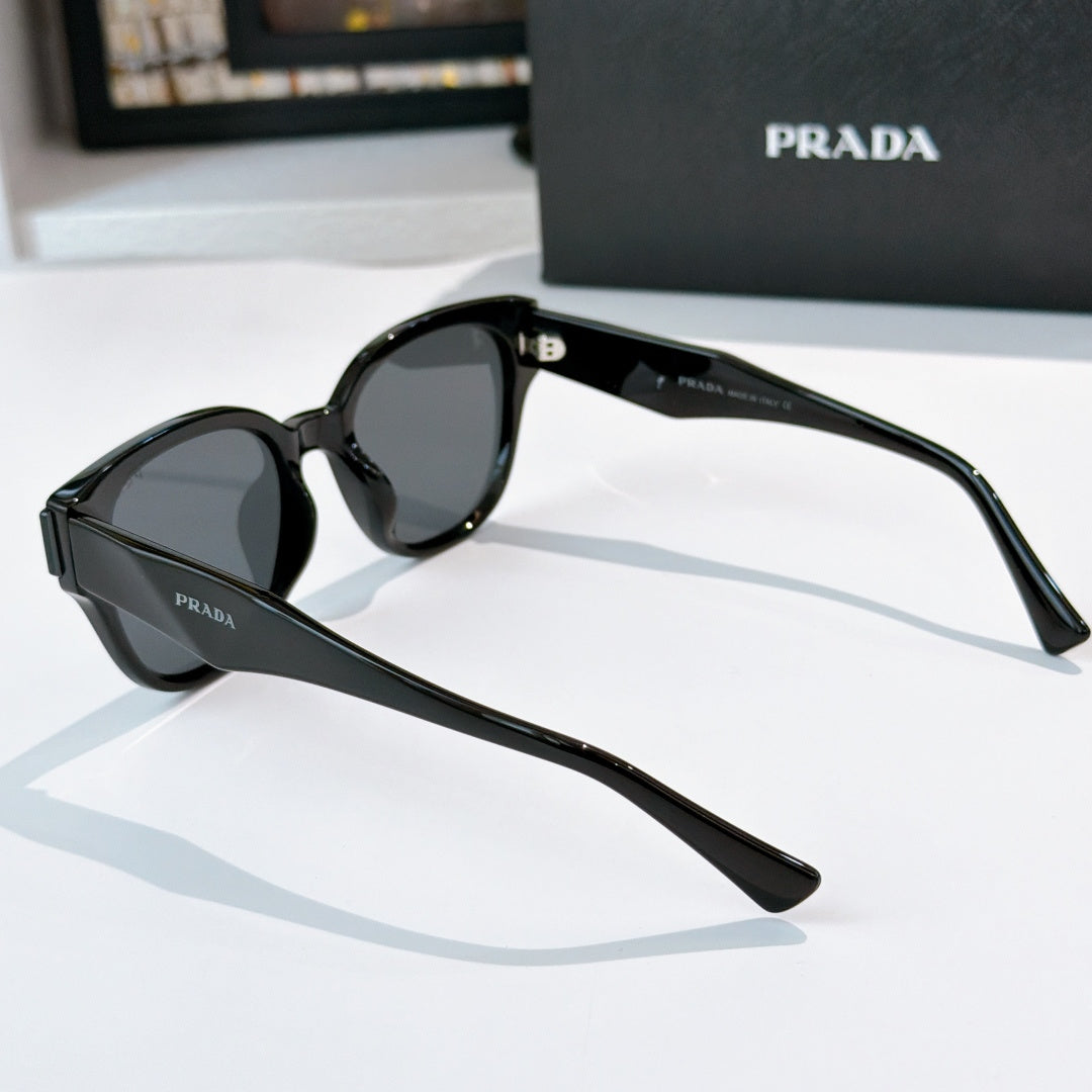 Prada black oval sunglasses with dark tinted lenses
