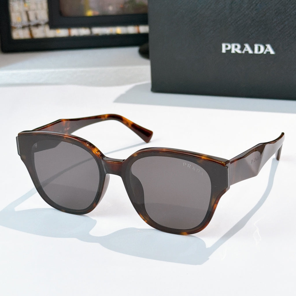 Prada tortoiseshell cat-eye sunglasses with dark tinted lenses