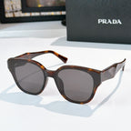 Prada tortoiseshell cat-eye sunglasses with dark tinted lenses