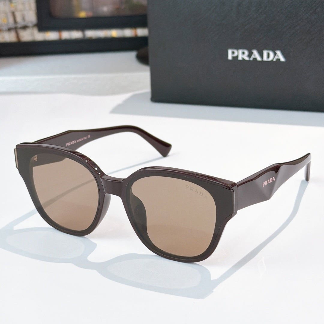 Prada dark gray cat-eye sunglasses with brown tinted lenses