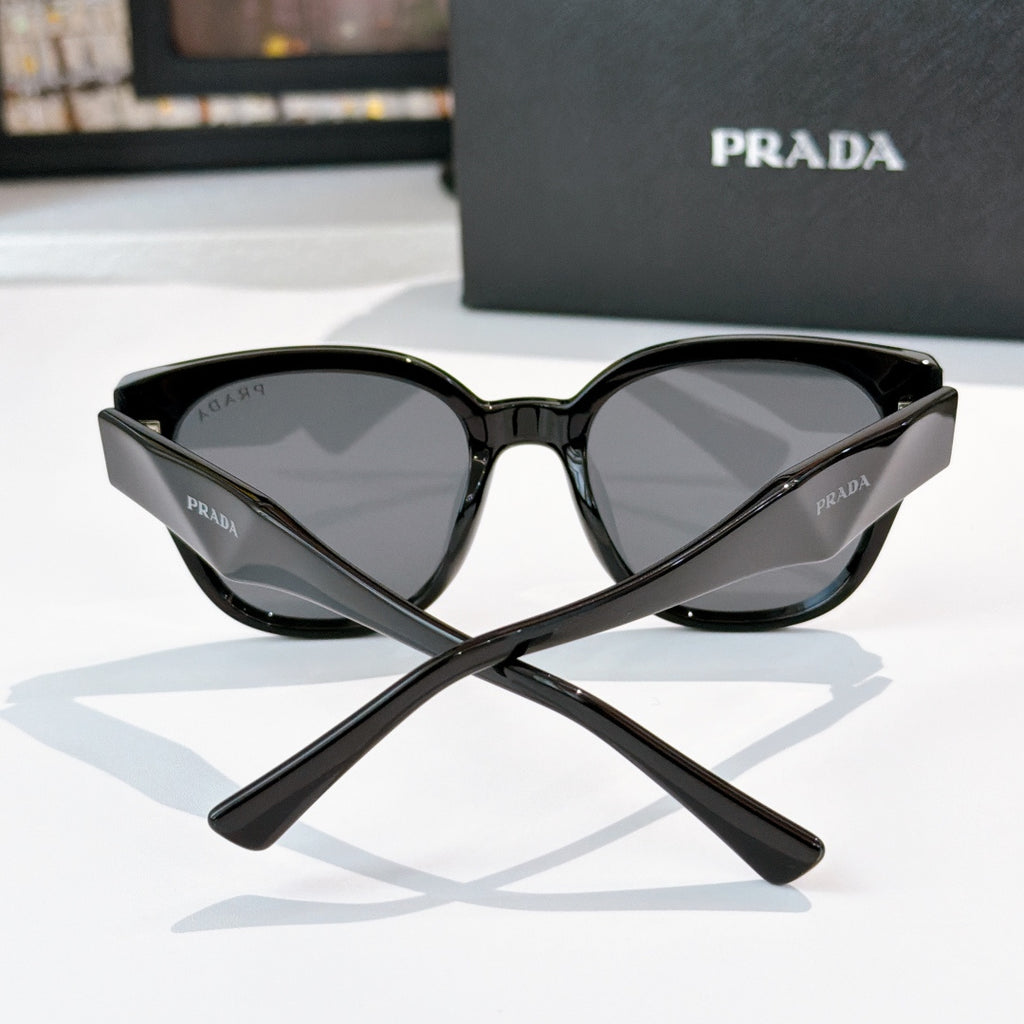 Prada black cat-eye sunglasses with dark tinted lenses