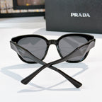 Prada black cat-eye sunglasses with dark tinted lenses