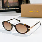 Bvlgari sunglasses with dark brown frames and tan oval lenses, gold temple detail