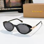 Bvlgari sunglasses with black frames and dark gray round lenses, gold bridge