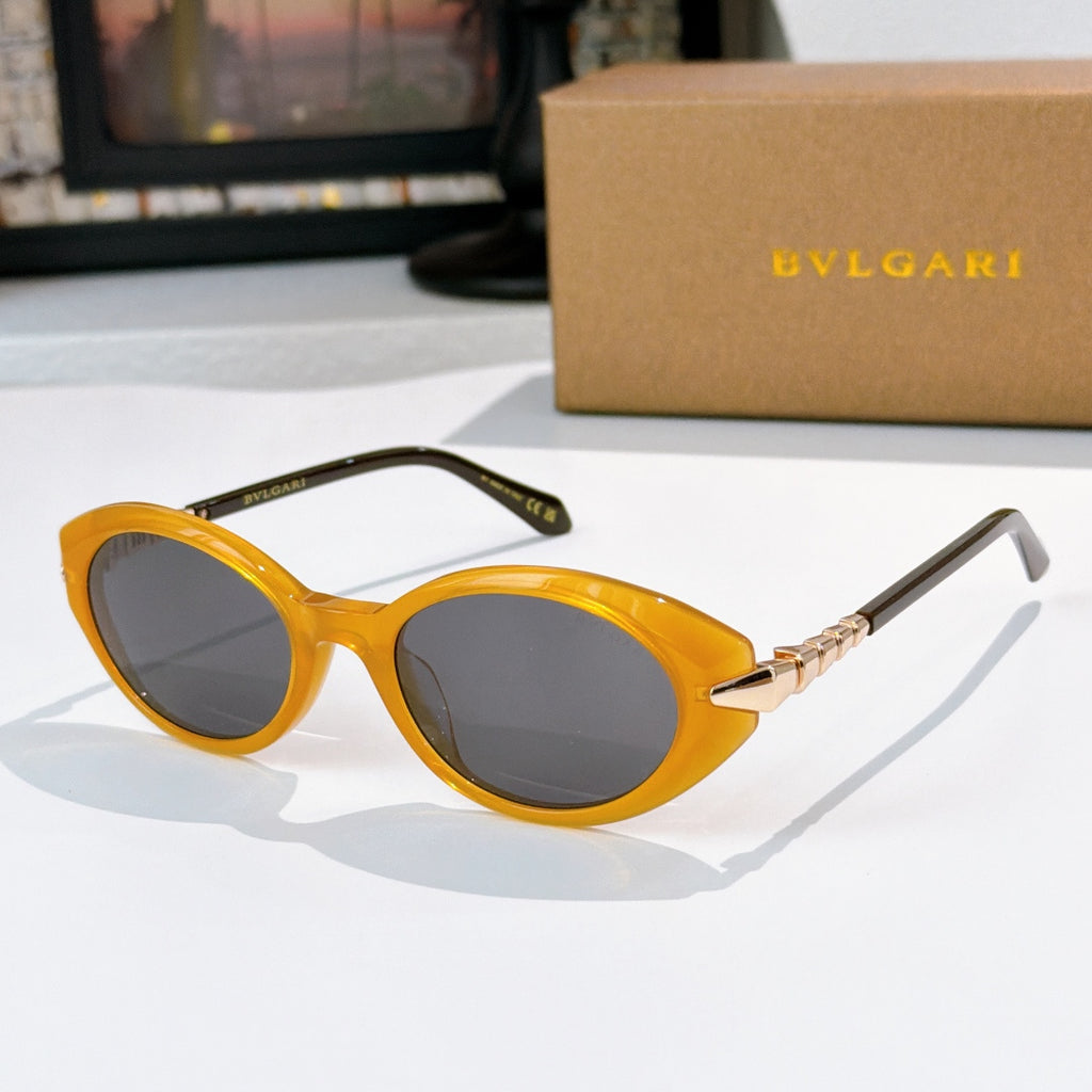 Bvlgari sunglasses with yellow frames and dark gray oval lenses, gold hinge