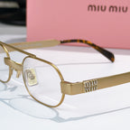 Gold-tone eyeglasses with clear lenses and engraved temple detail